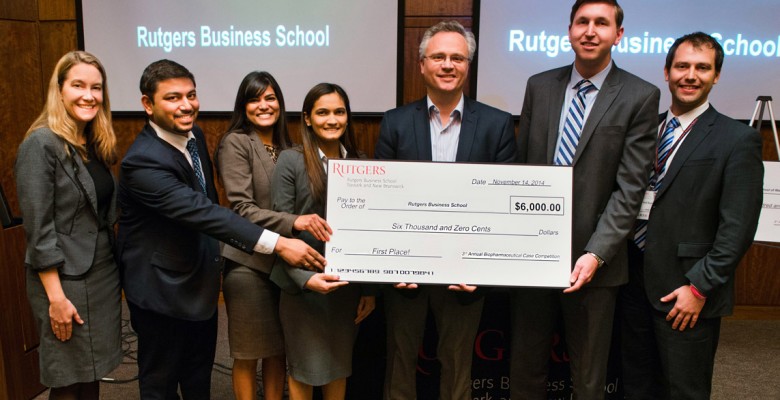 2014 competition winners hold up their large printed check