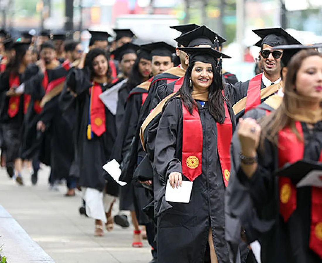 Graduates walking to the ceremony