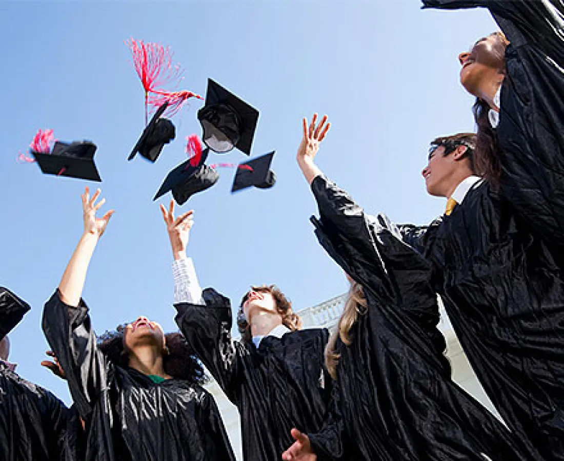 Students throwing their hats up in celebration