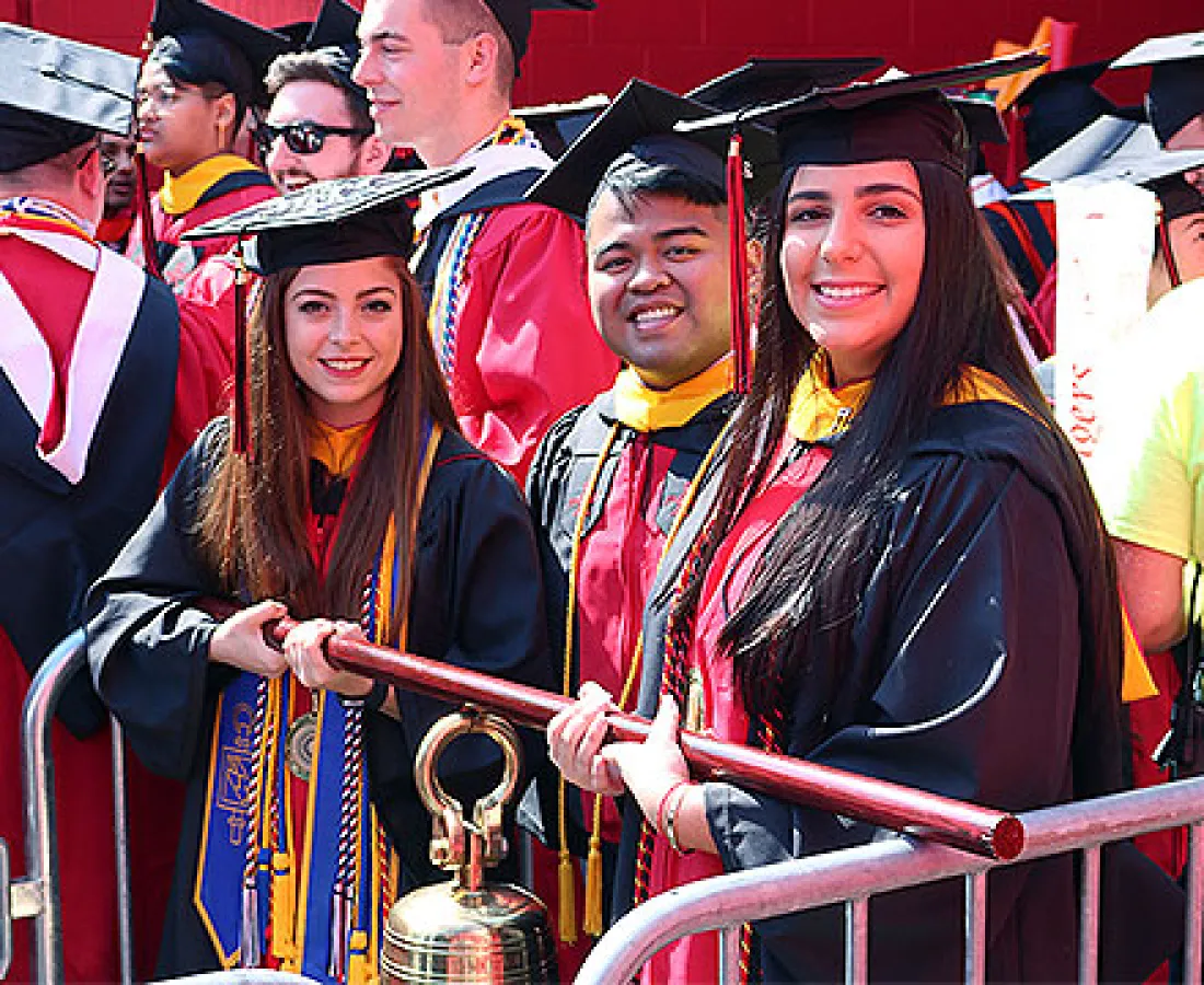 RBS graduates carry the bell at the university commencement ceremony