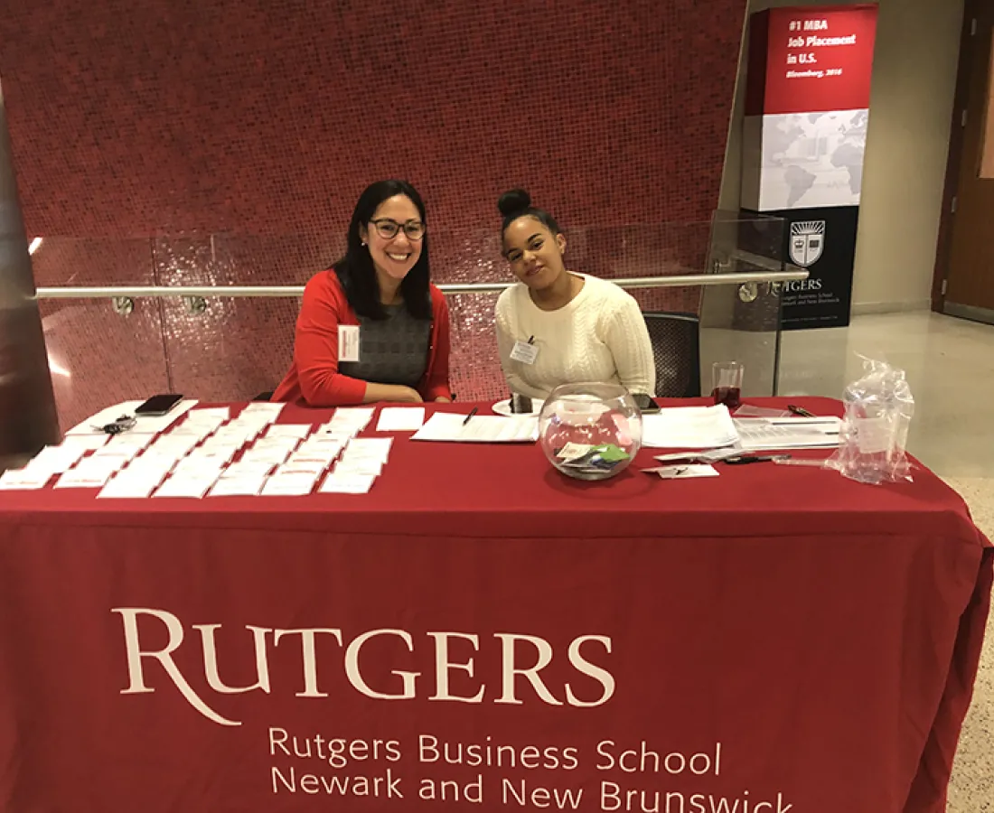 an RBS staff member and student worker working an event