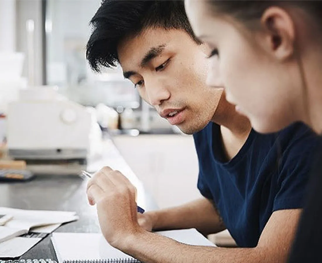 Students look over work together