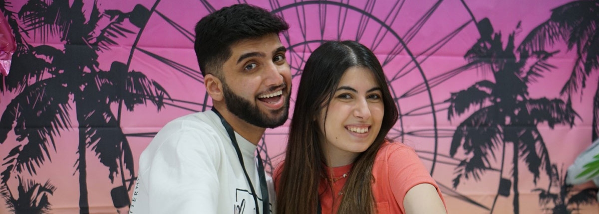 a pair of members posing