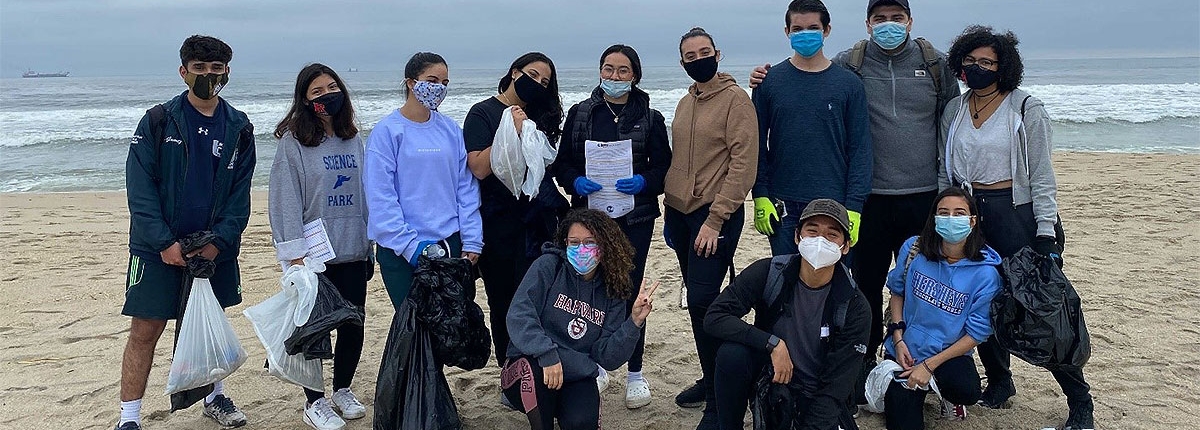 Members on a beach doing volunteer cleanup