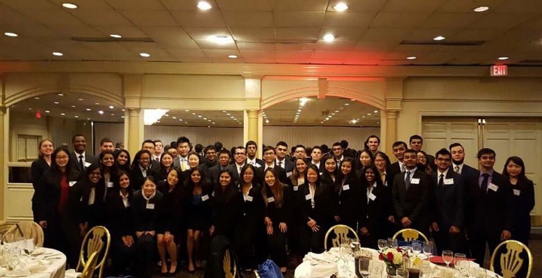 Members, looking professional, pose together for a group photo at a Beta Alpha Psi event