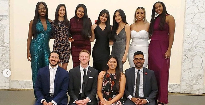 Members of the society pose for a group photo at the winter charity ball