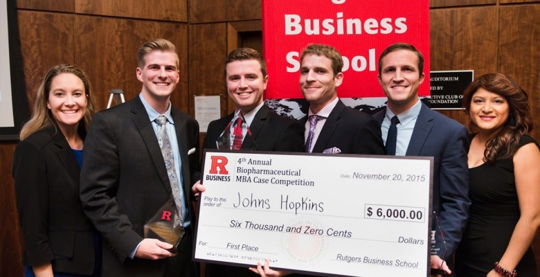 2015 competition winners hold up their large printed check