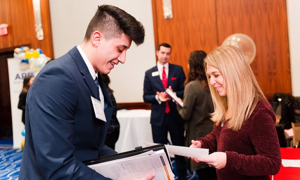Two people networking at a career fair