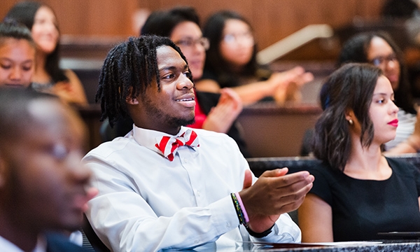 male student clapping during speech