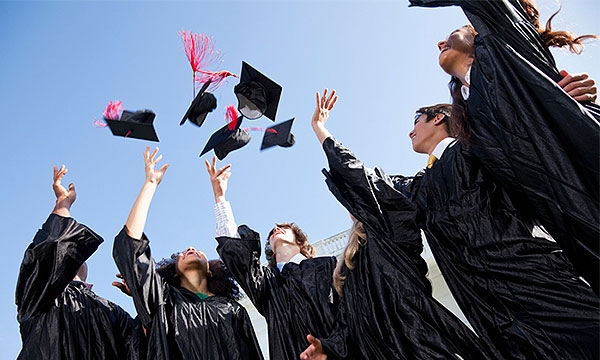 Students throwing their hats up in celebration