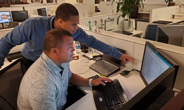 Student showing co-worker something on his computer