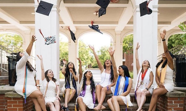 members throwing their graduation caps in celebration