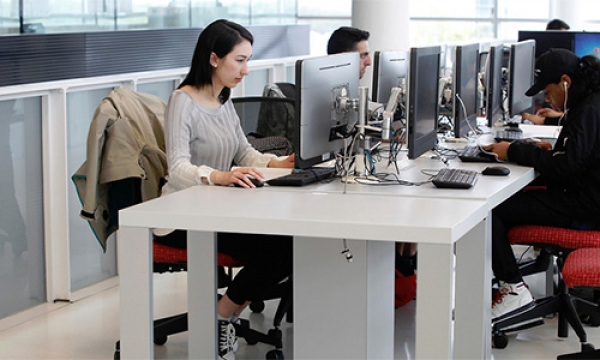 Student focused on her computer in computer lounge