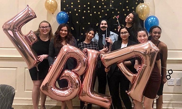 Members holding balloons that spell FBLA