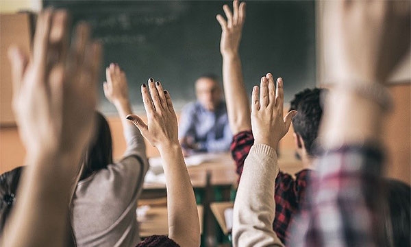 Hands raised in a classroom