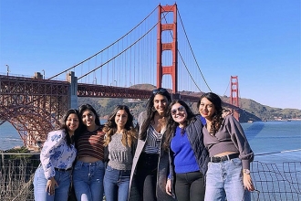 Members pose in front of the Golden Gate bridge