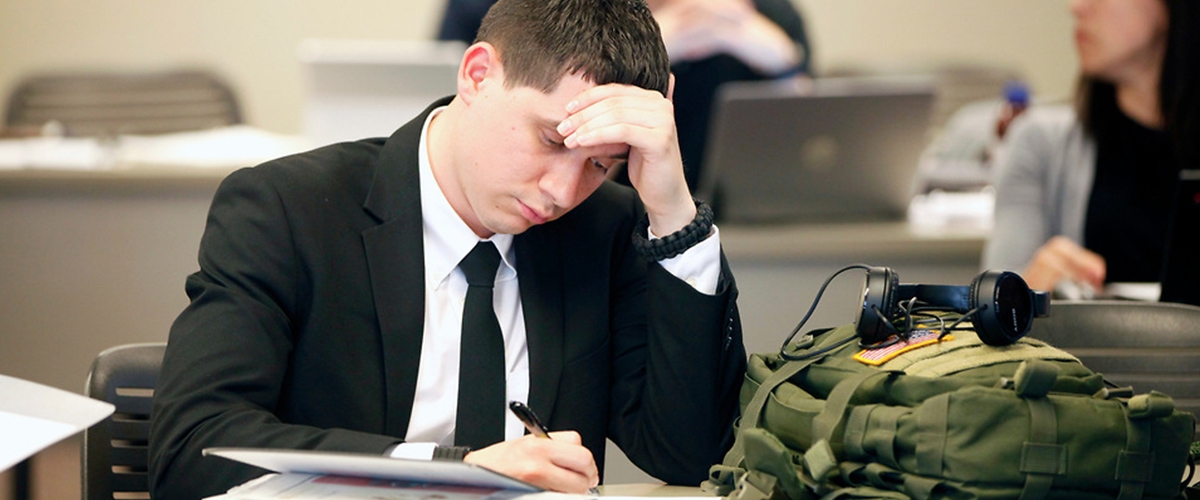 A student focused on the work in front of him.