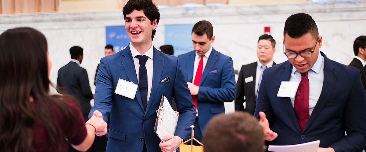Students and employers speaking at a career fair