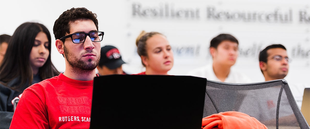 Students in class, one is on a laptop