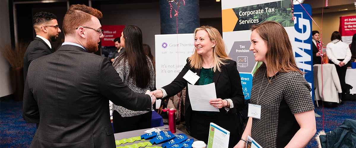 Students greeting employers at the career fair