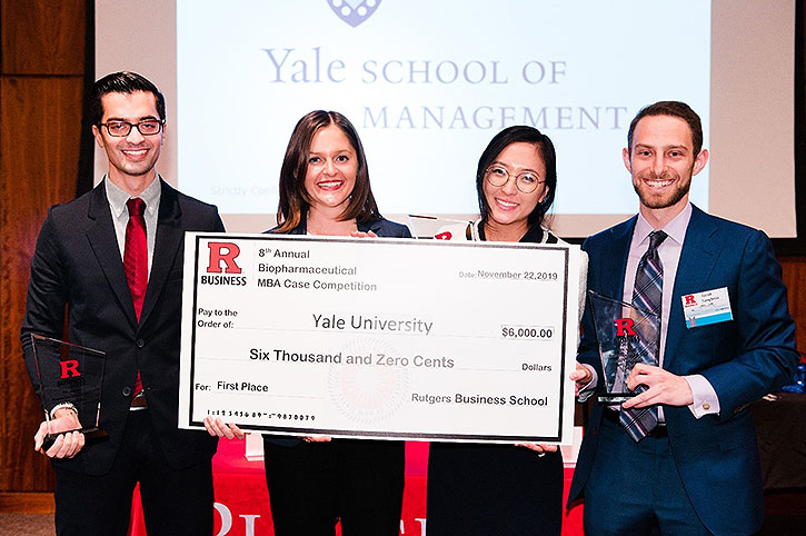Winning team from Yale holding novelty check